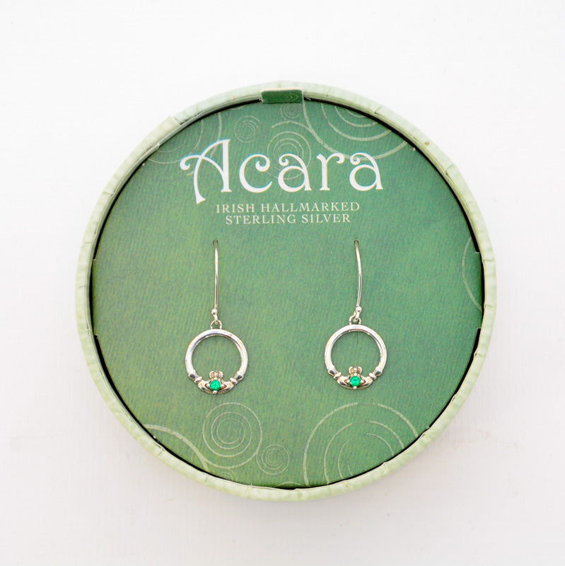 Silver hanging earrings with Claddagh rings, the heart has a green glass gem in the middle.