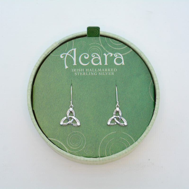 Silver hanging earrings with Trinity knot at the end. The knots are engraved with a dotted design at the corners, with clear glass gems on the three tips of the knots.